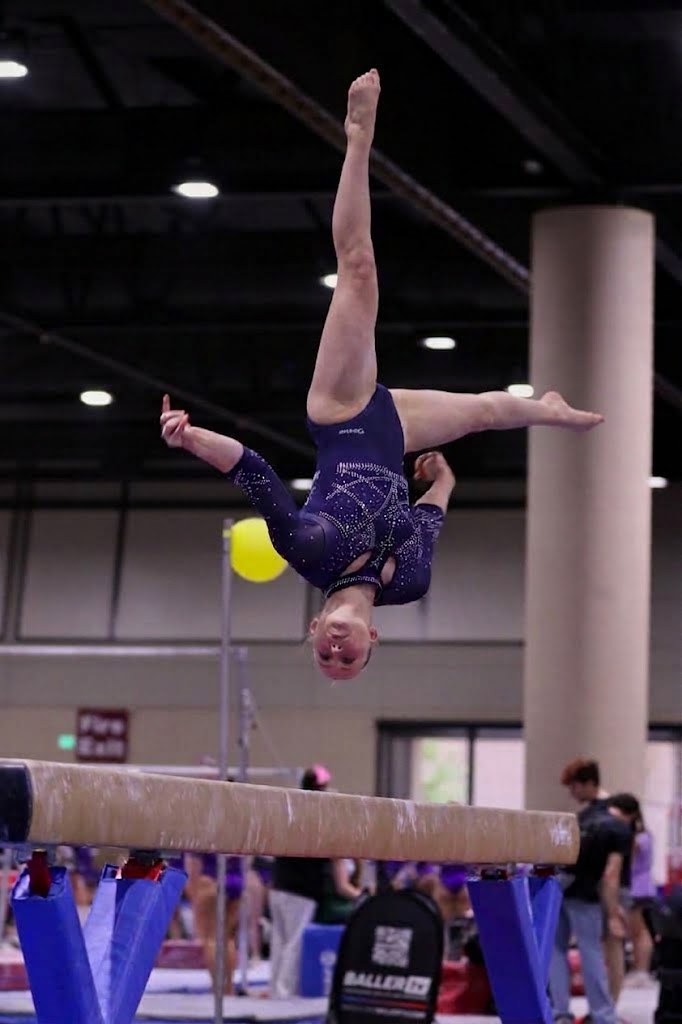 Ashley Carroll performing on beam