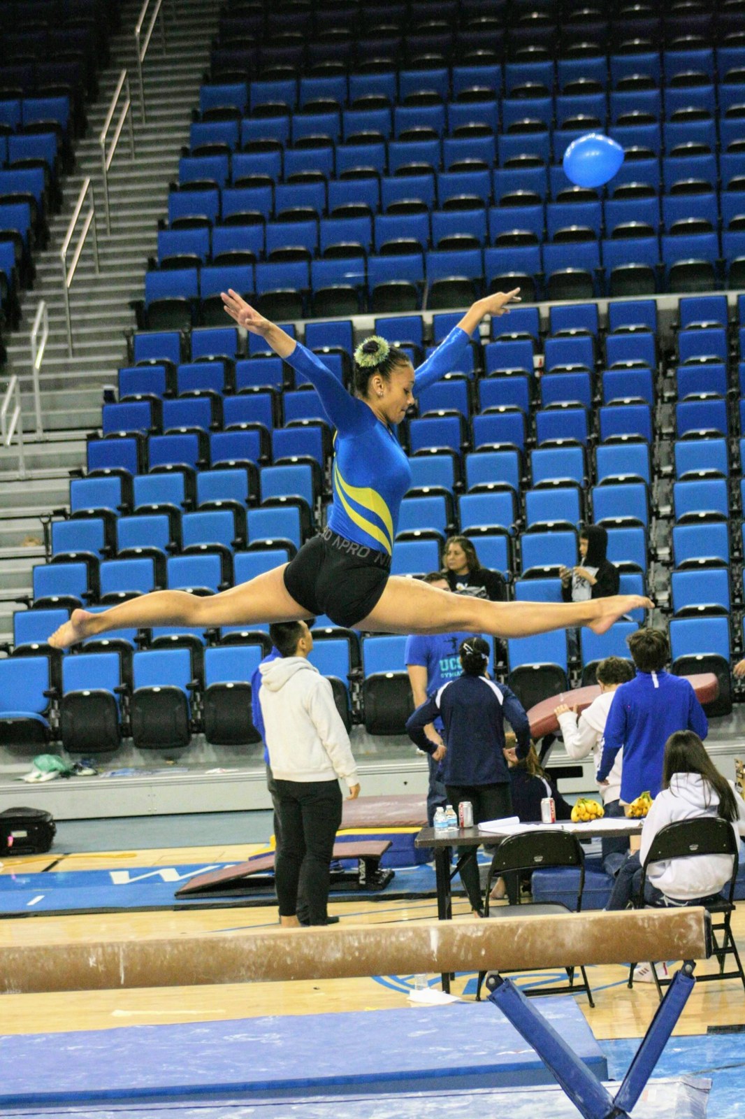 Brynnan Venters performing a split leap on beam