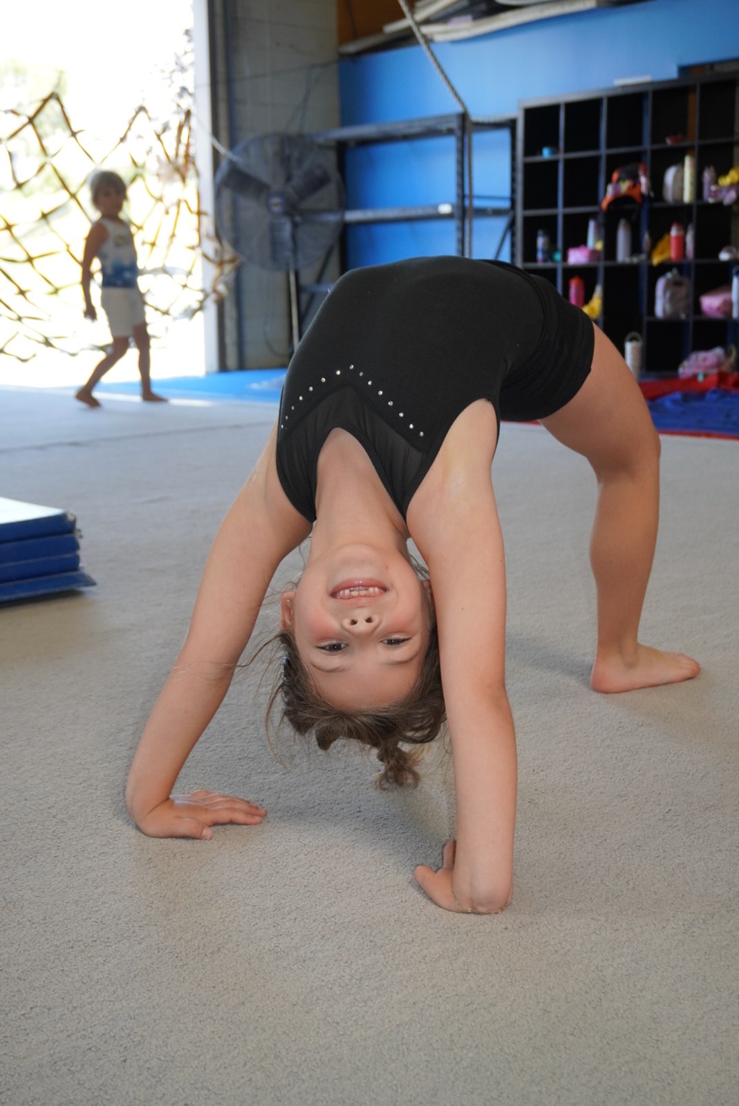 Young gymnast practicing a bridge