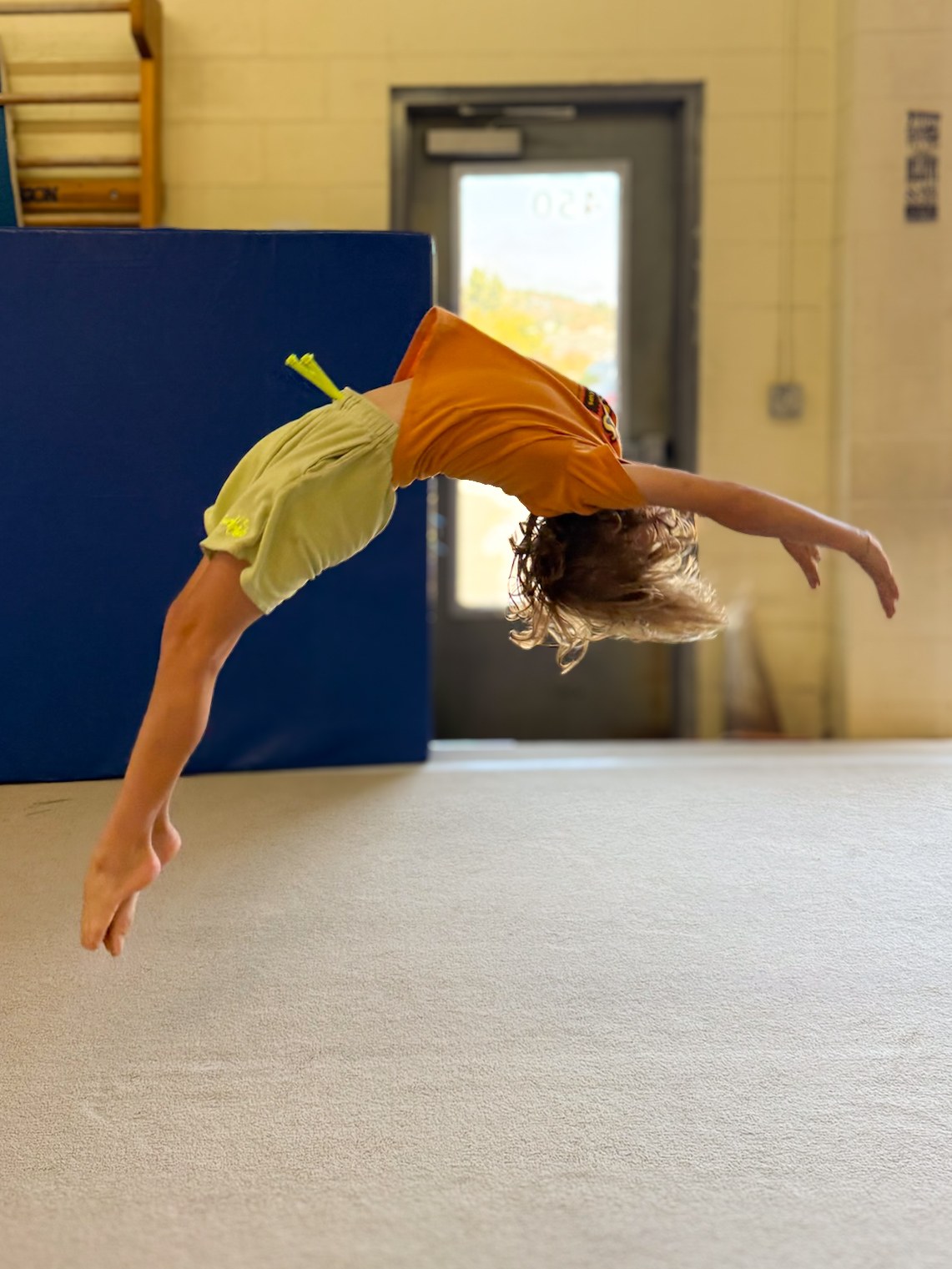 Gymnast practicing a back handspring