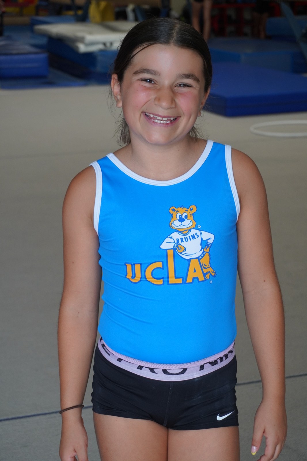 Smiling athlete in a UCLA leotard