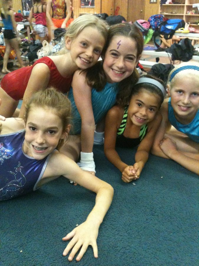 Gymnasts sharing a moment together in the gym