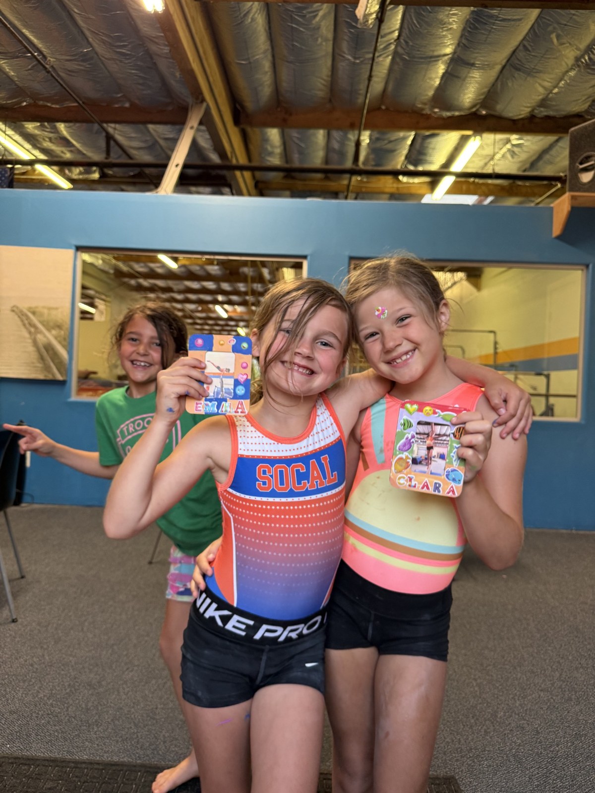Two friends smiling in leotards