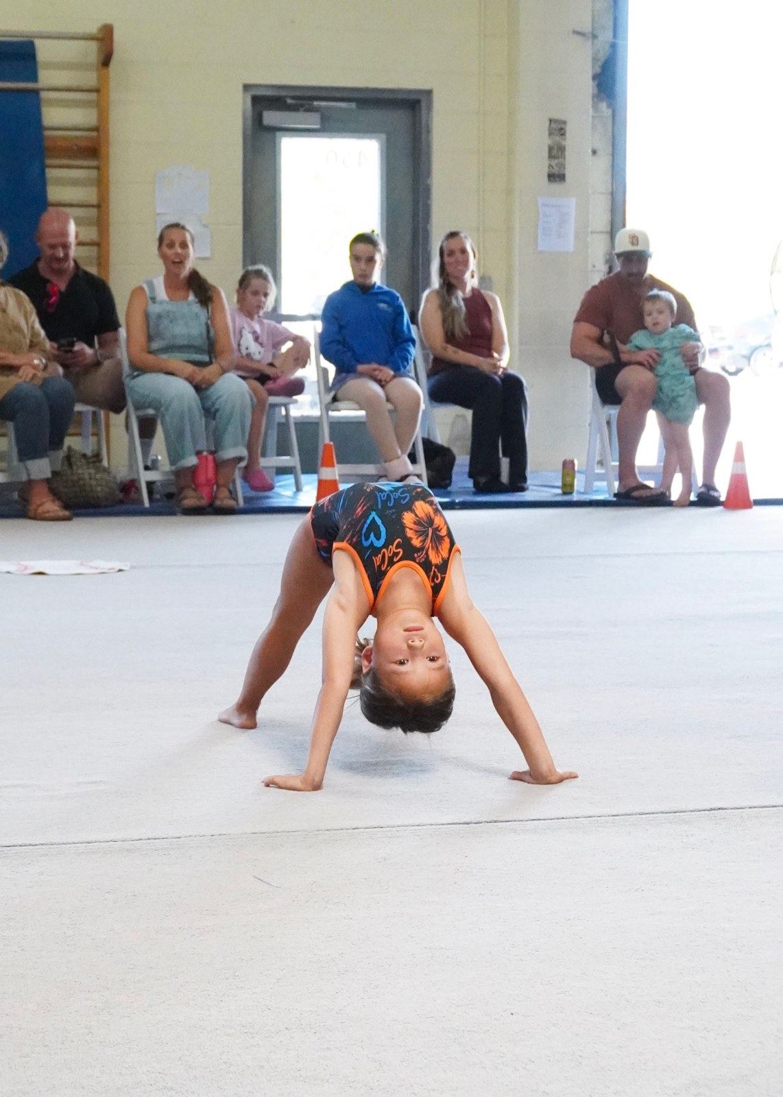 Gymnast doing a handstand on the floor