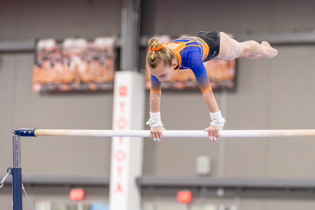 Gymnast swinging over the uneven bar