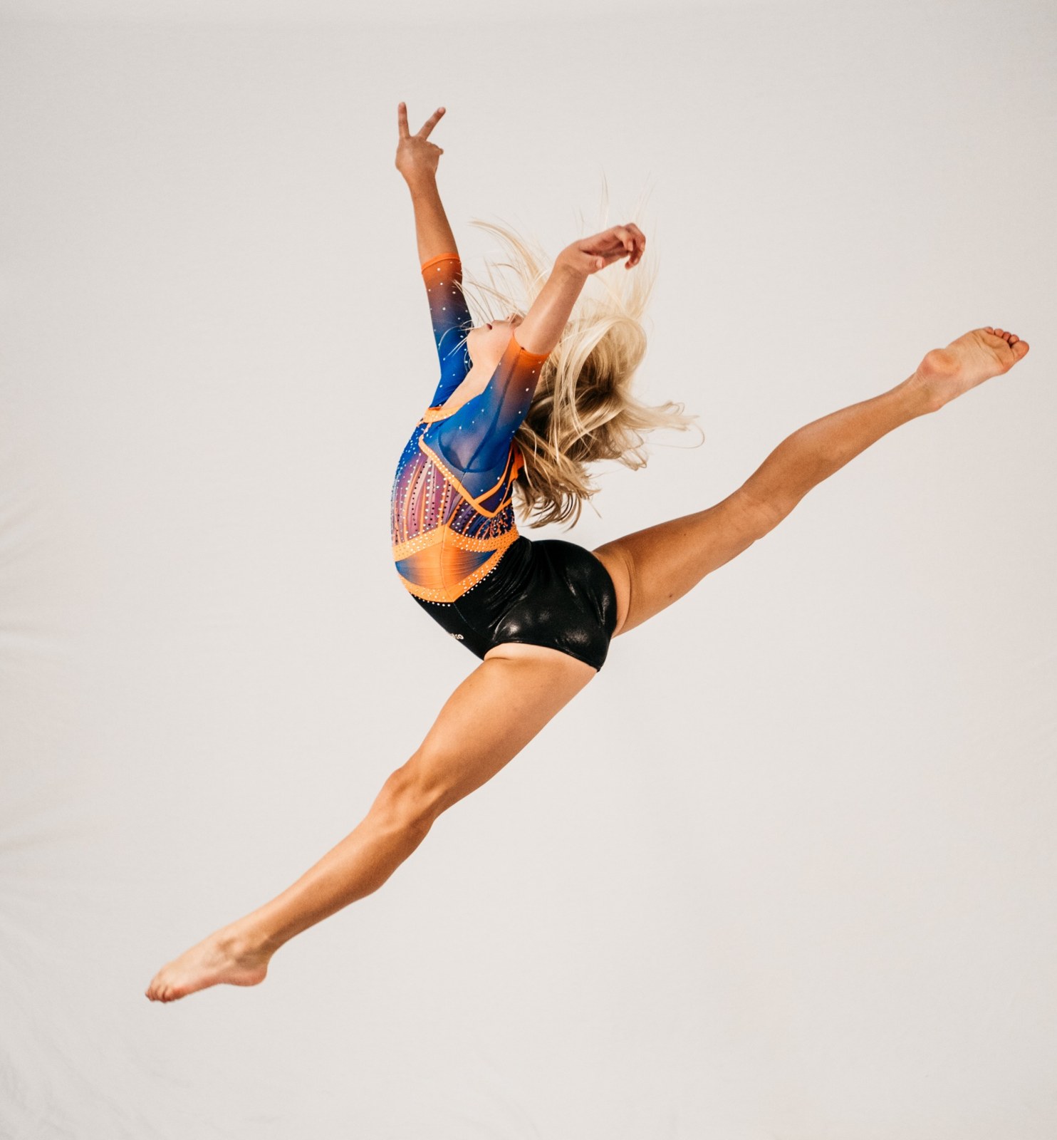 Gymnast performing a leap during floor practice