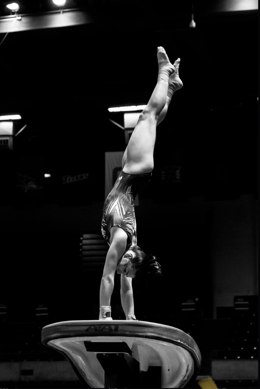 Collegiate gymnast performing on vault